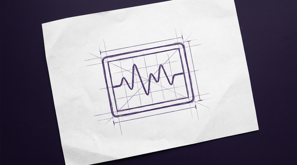 a medical monitor screen, viewed front-on, displaying a single, continuous, oscillating waveform line moving from left to right across a grid