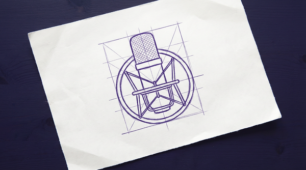 a large-diaphragm studio condenser microphone, viewed from the side, suspended upright within a circular shock mount frame by a web of elastic cords, with the microphone's cylindrical body and fine mesh grille head visible at the center of the mount