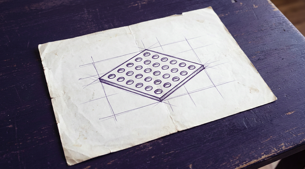 a flat, square metal sheet, viewed in perspective from an angle above, perforated by a uniform grid of clean, circular through-holes