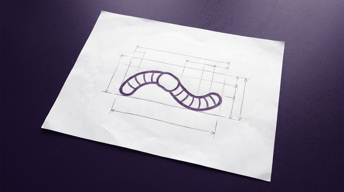 an earthworm with distinct ring-like segments and a smooth saddle-like clitellum along its curved cylindrical body