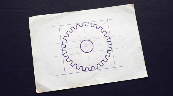 a single, flat, circular machine gear, viewed face-on, with uniform teeth around its outer edge and a central hole for mounting