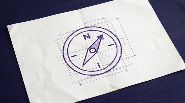 a simple, circular handheld magnetic compass, viewed from directly above, with its prominent needle pointing towards the 'N' marking for north on its face