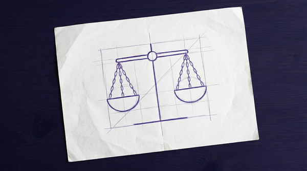 a classic balance scale with two circular pans suspended by chains from either end of a centrally pivoted horizontal beam