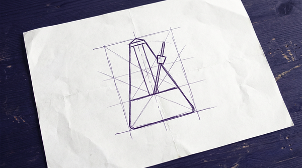 a classic, pyramid-shaped mechanical metronome with its weighted pendulum arm at rest in the vertical center position