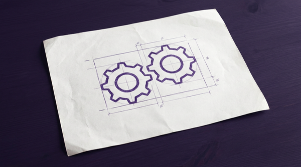a pair of circular, toothed cogwheels, positioned side-by-side as if intended to interlock, but are shown slightly separated and rotationally misaligned, preventing their teeth from meshing and transferring motion