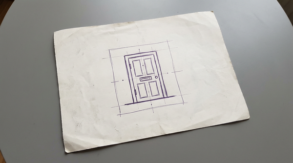 a closed wooden door with a mail slot
