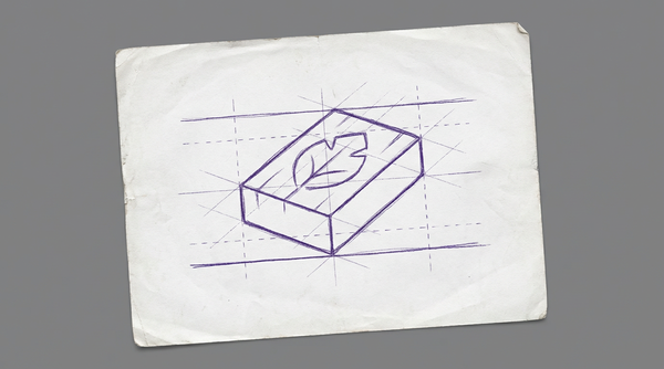 a rectangular block of wood with a simple, half-finished carving of a leaf on its surface