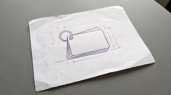a small stack of cue cards, held together by a single metal ring in the top-left corner