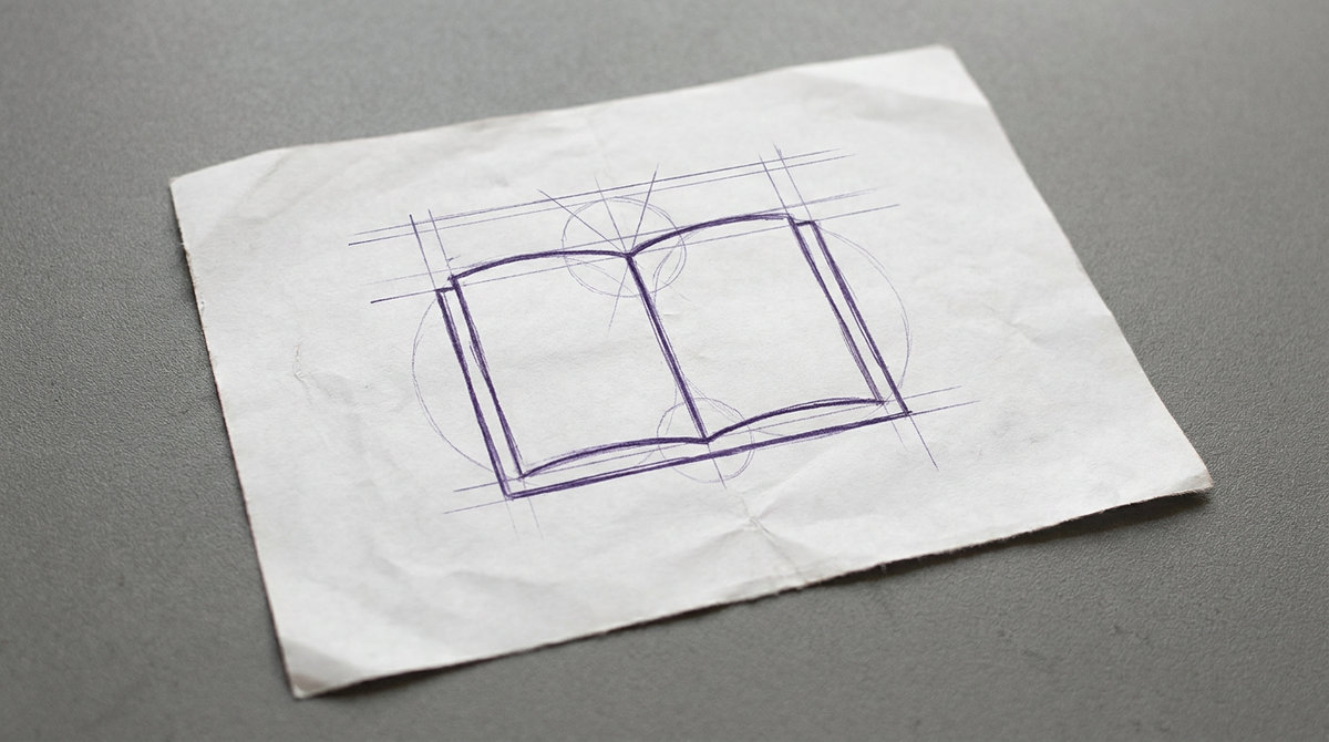 an open hardcover book, shown lying flat with blank pages spread out from the central spine